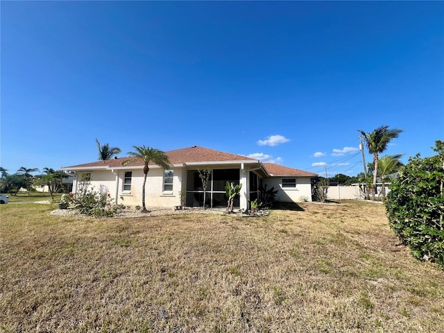 1155 Osceola Blvd, Englewood, FL 34223 - back of house featuring fence, stucco siding, and a lawn