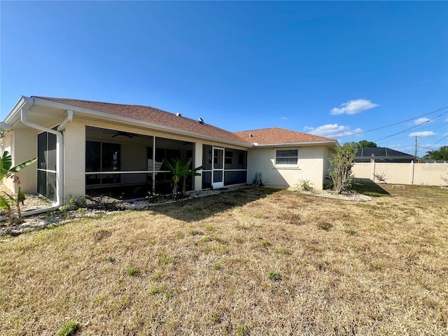 1155 Osceola Blvd, Englewood, FL 34223 - rear view of property with a sunroom, a yard, stucco siding, and fence