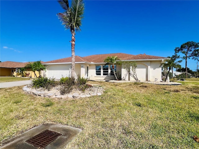 1155 Osceola Blvd, Englewood, FL 34223 - ranch-style house with a garage, stucco siding, and a front yard