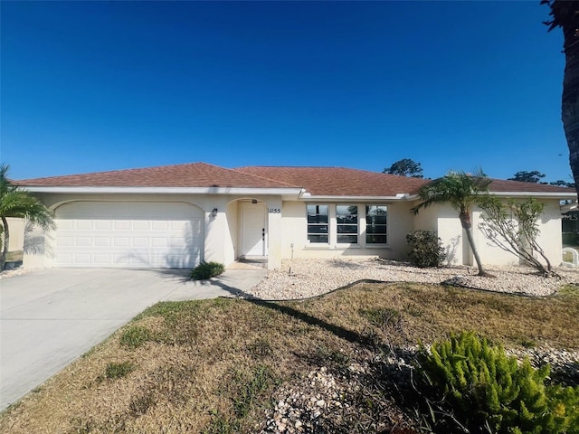 1155 Osceola Blvd, Englewood, FL 34223 - ranch-style house featuring concrete driveway, stucco siding, and a garage