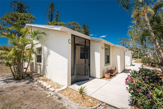 6796 Gasparilla Pines Blvd Unit 63, Englewood, FL 34224 - rear view of house with stucco siding