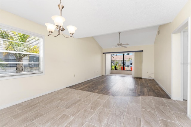 6796 Gasparilla Pines Blvd Unit 63, Englewood, FL 34224 - spare room featuring light wood finished floors, ceiling fan with notable chandelier, a healthy amount of sunlight, and vaulted ceiling