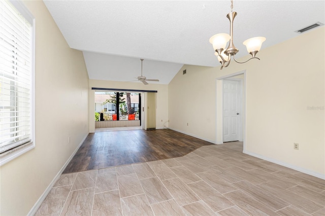 6796 Gasparilla Pines Blvd Unit 63, Englewood, FL 34224 - empty room featuring light wood finished floors, ceiling fan with notable chandelier, baseboards, lofted ceiling, and visible vents