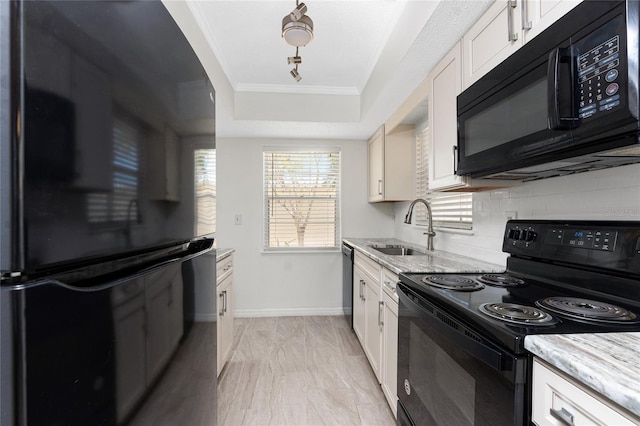 6796 Gasparilla Pines Blvd Unit 63, Englewood, FL 34224 - kitchen with light stone countertops, a tray ceiling, a sink, backsplash, and black appliances