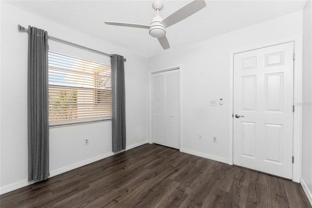 6796 Gasparilla Pines Blvd Unit 63, Englewood, FL 34224 - unfurnished bedroom featuring a closet, dark wood-style flooring, and baseboards