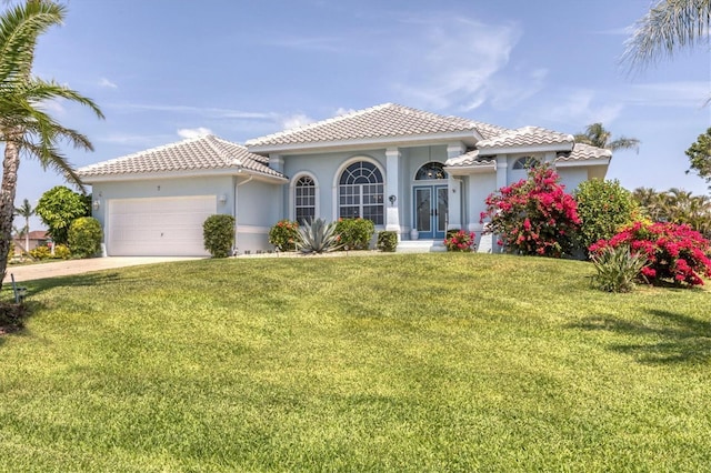 11 Amberjack Ln, Placida, FL 33946 - mediterranean / spanish-style home with stucco siding, driveway, a front lawn, and a garage