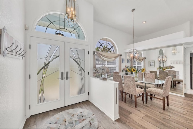 11 Amberjack Ln, Placida, FL 33946 - foyer entrance with an inviting chandelier, a towering ceiling, baseboards, french doors, and light wood-style flooring
