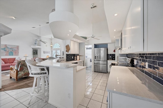 11 Amberjack Ln, Placida, FL 33946 - kitchen featuring ceiling fan, open floor plan, decorative backsplash, and stainless steel fridge with ice dispenser