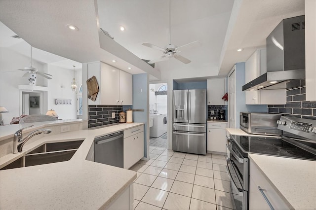 11 Amberjack Ln, Placida, FL 33946 - kitchen featuring a ceiling fan, a sink, wall chimney range hood, and stainless steel appliances