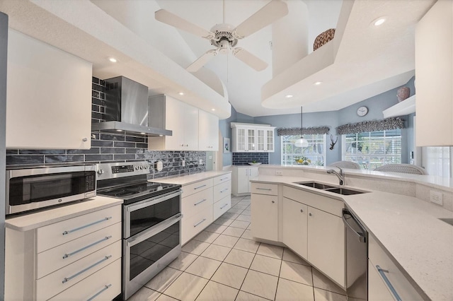 11 Amberjack Ln, Placida, FL 33946 - kitchen featuring wall chimney range hood, tasteful backsplash, light countertops, a sink, and stainless steel appliances