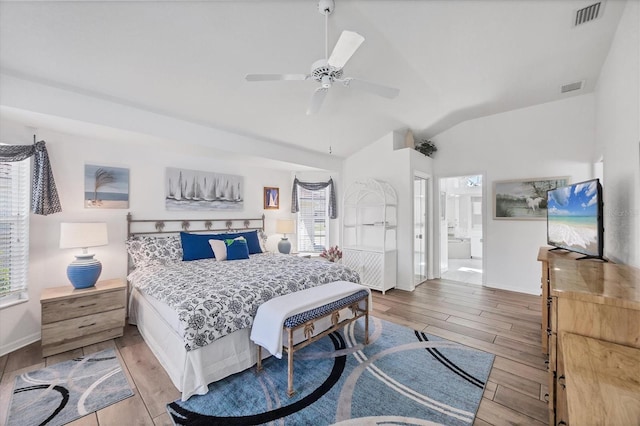 11 Amberjack Ln, Placida, FL 33946 - bedroom with vaulted ceiling, multiple windows, and light wood-style flooring