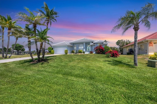 11 Amberjack Ln, Placida, FL 33946 - single story home with a tiled roof, a front yard, concrete driveway, an attached garage, and stucco siding