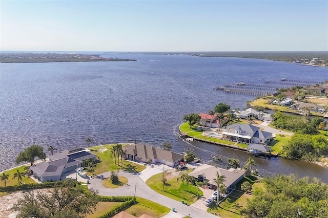 birds eye view of property with a water view and a residential view