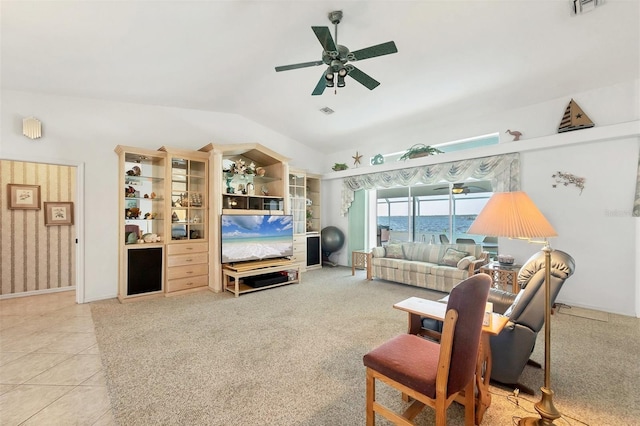 living room featuring ceiling fan, visible vents, and lofted ceiling