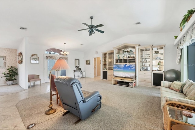 tiled living area featuring a ceiling fan, visible vents, and lofted ceiling