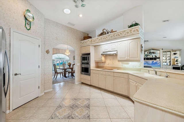kitchen featuring visible vents, appliances with stainless steel finishes, a sink, under cabinet range hood, and wallpapered walls