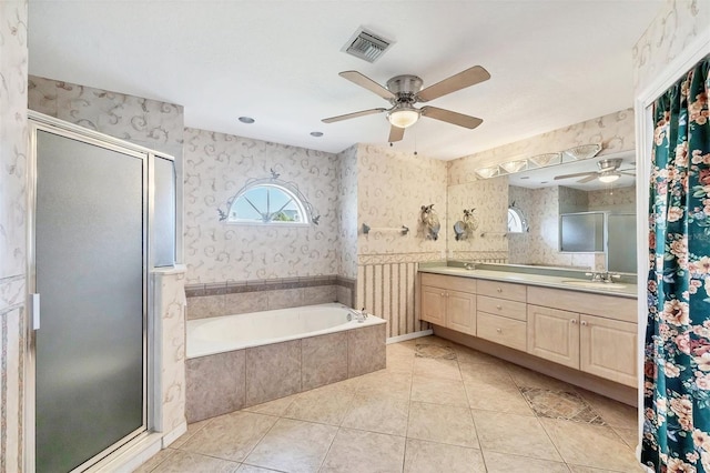 bathroom featuring a sink, a ceiling fan, wallpapered walls, and visible vents
