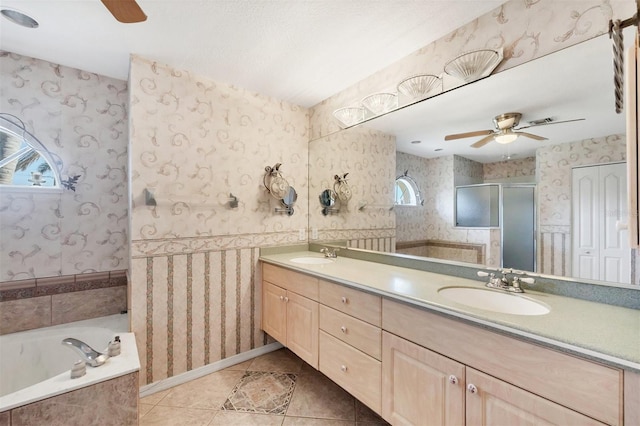 bathroom featuring ceiling fan, wallpapered walls, a sink, and tile patterned floors