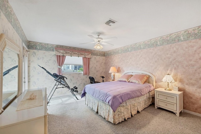 carpeted bedroom with visible vents, a ceiling fan, baseboards, and wallpapered walls