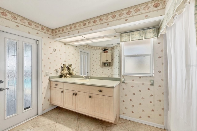 full bathroom featuring vanity, tile patterned flooring, baseboards, and wallpapered walls