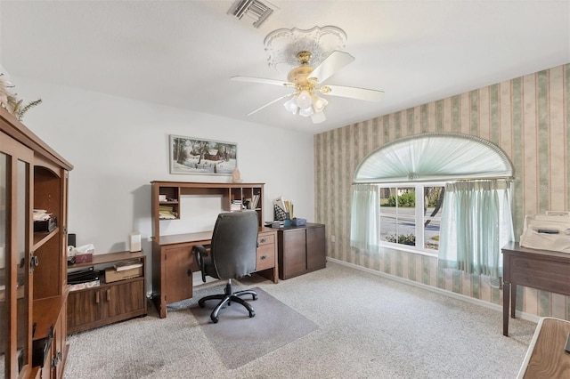 office with ceiling fan, visible vents, baseboards, light carpet, and wallpapered walls