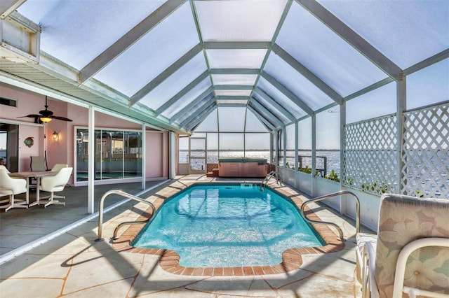 outdoor pool featuring a lanai, ceiling fan, a hot tub, and a patio area