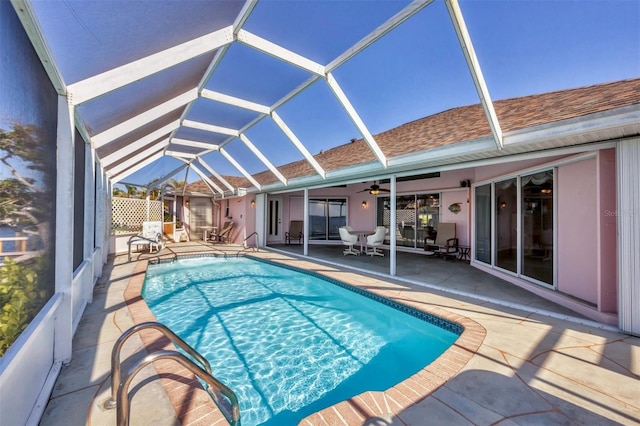 view of pool featuring a fenced in pool, a ceiling fan, glass enclosure, and a patio area