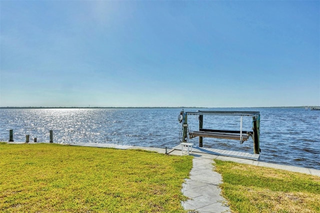 dock area with a yard and a water view