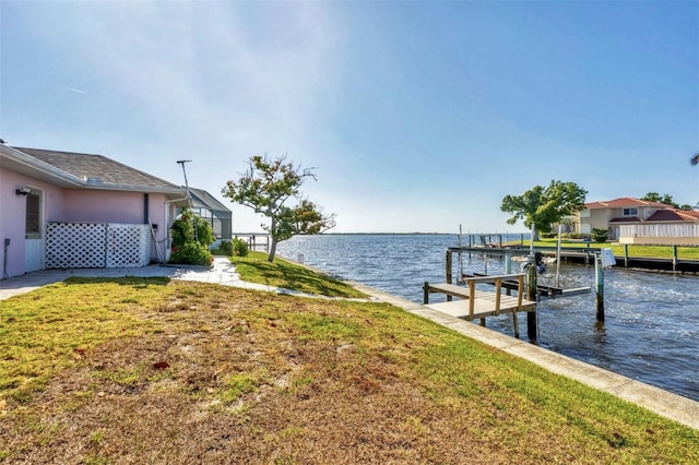 dock area featuring a yard, a water view, and boat lift