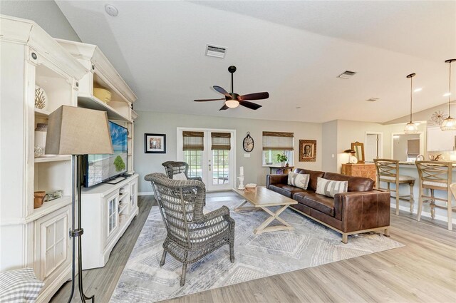 9211 Koma St, Port Charlotte, FL 33981 - living area with a ceiling fan, light wood finished floors, visible vents, and vaulted ceiling