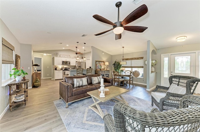 9211 Koma St, Port Charlotte, FL 33981 - living area with light wood-style floors, baseboards, lofted ceiling, and a ceiling fan