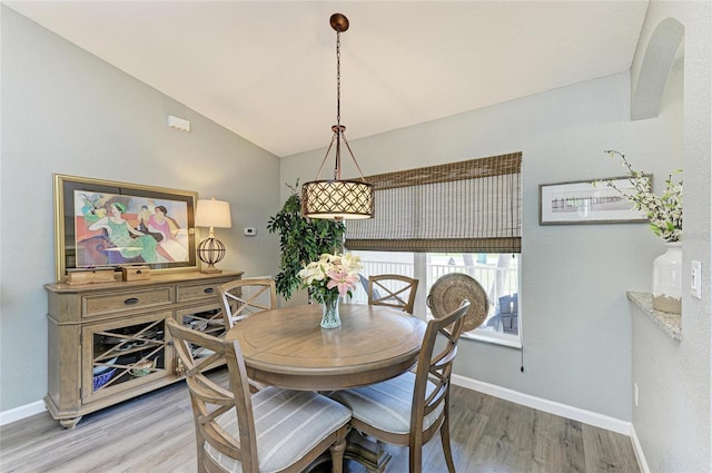 9211 Koma St, Port Charlotte, FL 33981 - dining area featuring lofted ceiling, baseboards, and light wood-style flooring