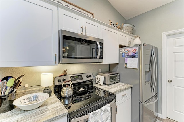 9211 Koma St, Port Charlotte, FL 33981 - kitchen featuring white cabinets, appliances with stainless steel finishes, light stone counters, and a toaster