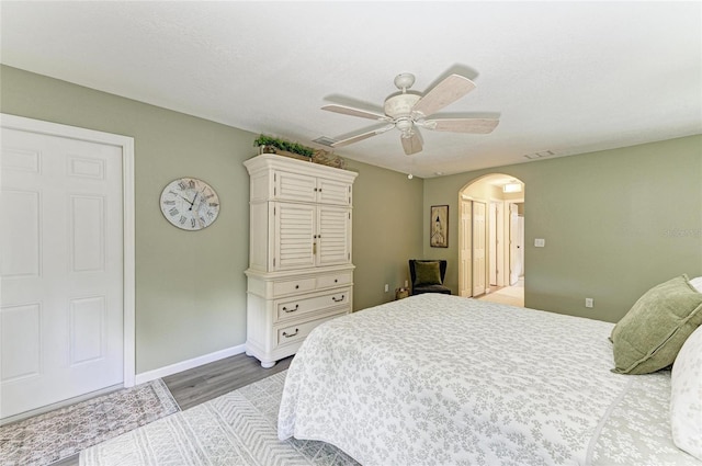 9211 Koma St, Port Charlotte, FL 33981 - bedroom with arched walkways, baseboards, visible vents, and wood finished floors