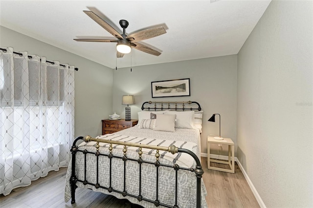 9211 Koma St, Port Charlotte, FL 33981 - bedroom with baseboards, a ceiling fan, and wood finished floors