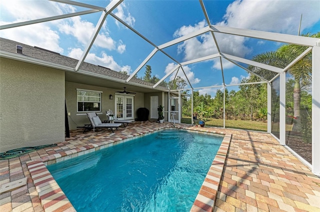 9211 Koma St, Port Charlotte, FL 33981 - outdoor pool with ceiling fan, a patio area, french doors, and glass enclosure