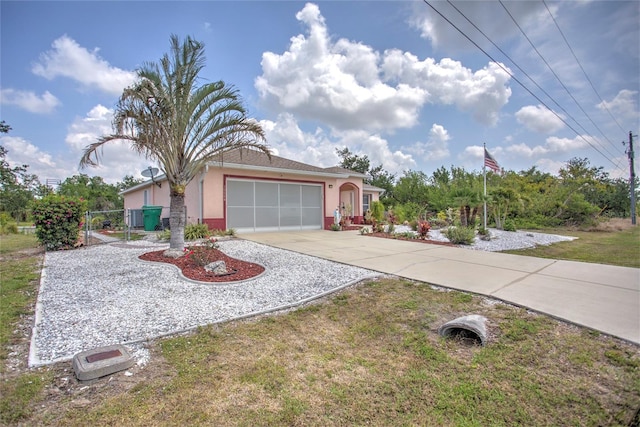 view of front of property featuring driveway, stucco siding, a garage, and a gate