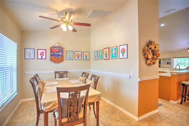 dining room with a ceiling fan, light tile patterned floors, and visible vents