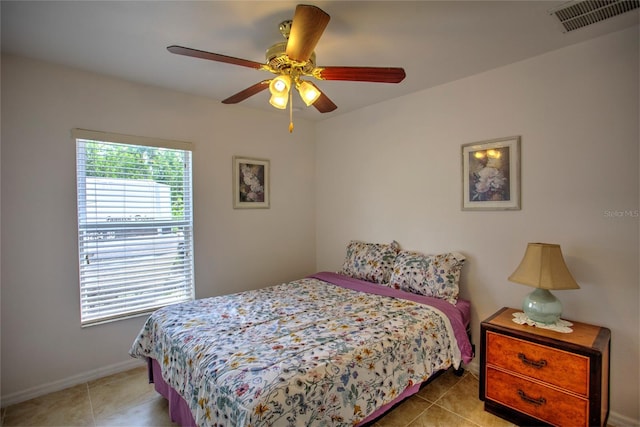 tiled bedroom with baseboards, a ceiling fan, and visible vents