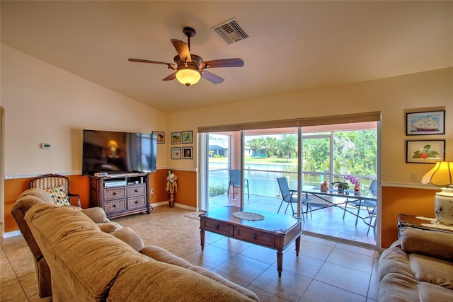 living room with visible vents, vaulted ceiling, a ceiling fan, light tile patterned floors, and baseboards