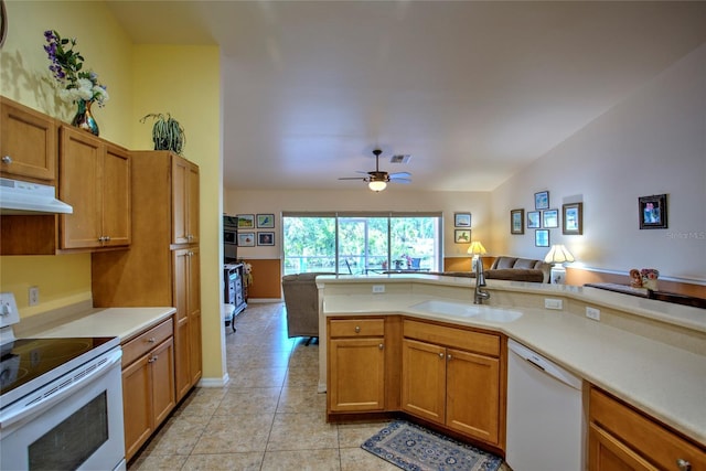 kitchen with a sink, open floor plan, visible vents, white appliances, and under cabinet range hood