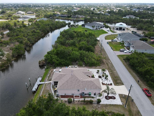 birds eye view of property with a water view and a residential view