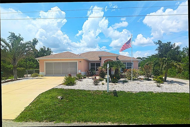 10064 Cocoa Beach St, Port Charlotte, FL 33981 - ranch-style house with stucco siding, driveway, a garage, and a front lawn