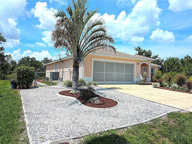 10064 Cocoa Beach St, Port Charlotte, FL 33981 - ranch-style home with a garage, concrete driveway, stucco siding, and a gate