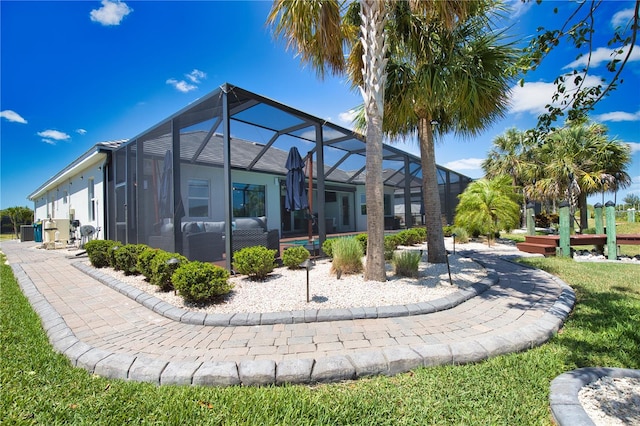 15176 Spanish Point Dr, Port Charlotte, FL 33981 - rear view of property featuring a lanai and a patio