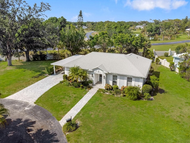 1 Curacao Cir Unit 44, Englewood, FL 34223 - view of front of home with decorative driveway, a water view, and view of scattered trees