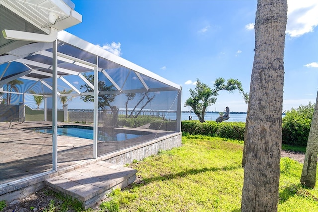 4093 Pelican Shores Cir, Englewood, FL 34223 - view of grassy yard featuring glass enclosure, an outdoor pool, a water view, and a patio area