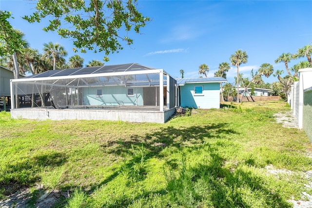 4093 Pelican Shores Cir, Englewood, FL 34223 - back of house with a lawn and glass enclosure