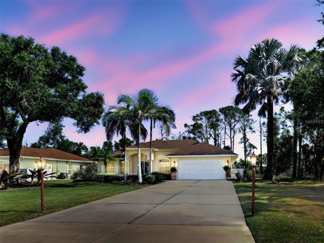 237 Rotonda Blvd E, Rotonda West, FL 33947 - ranch-style house featuring a front lawn, a garage, driveway, and stucco siding