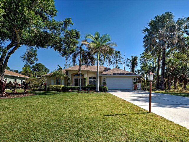 237 Rotonda Blvd E, Rotonda West, FL 33947 - ranch-style home featuring an attached garage, a front lawn, driveway, and stucco siding